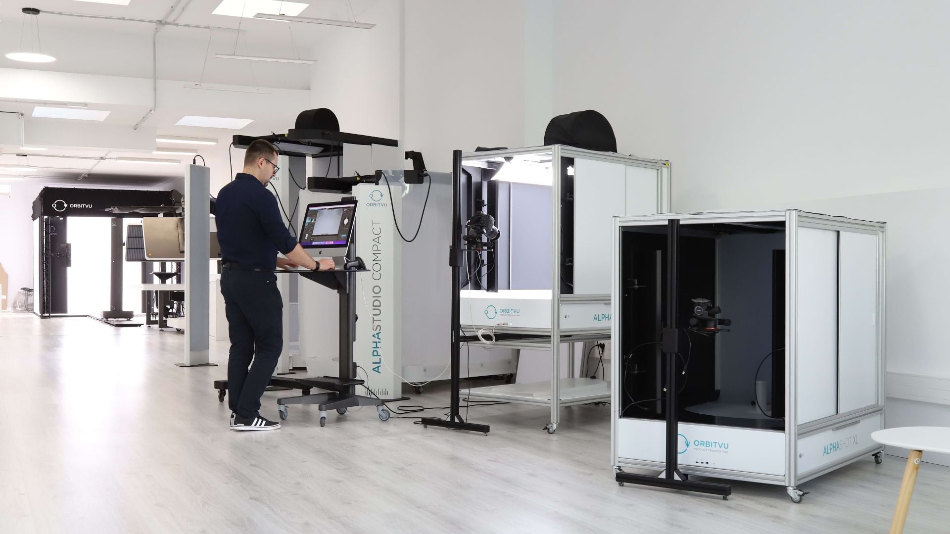 Operatore di studio e-commerce al lavoro con i sistemi di automazione fotografica Orbitvu